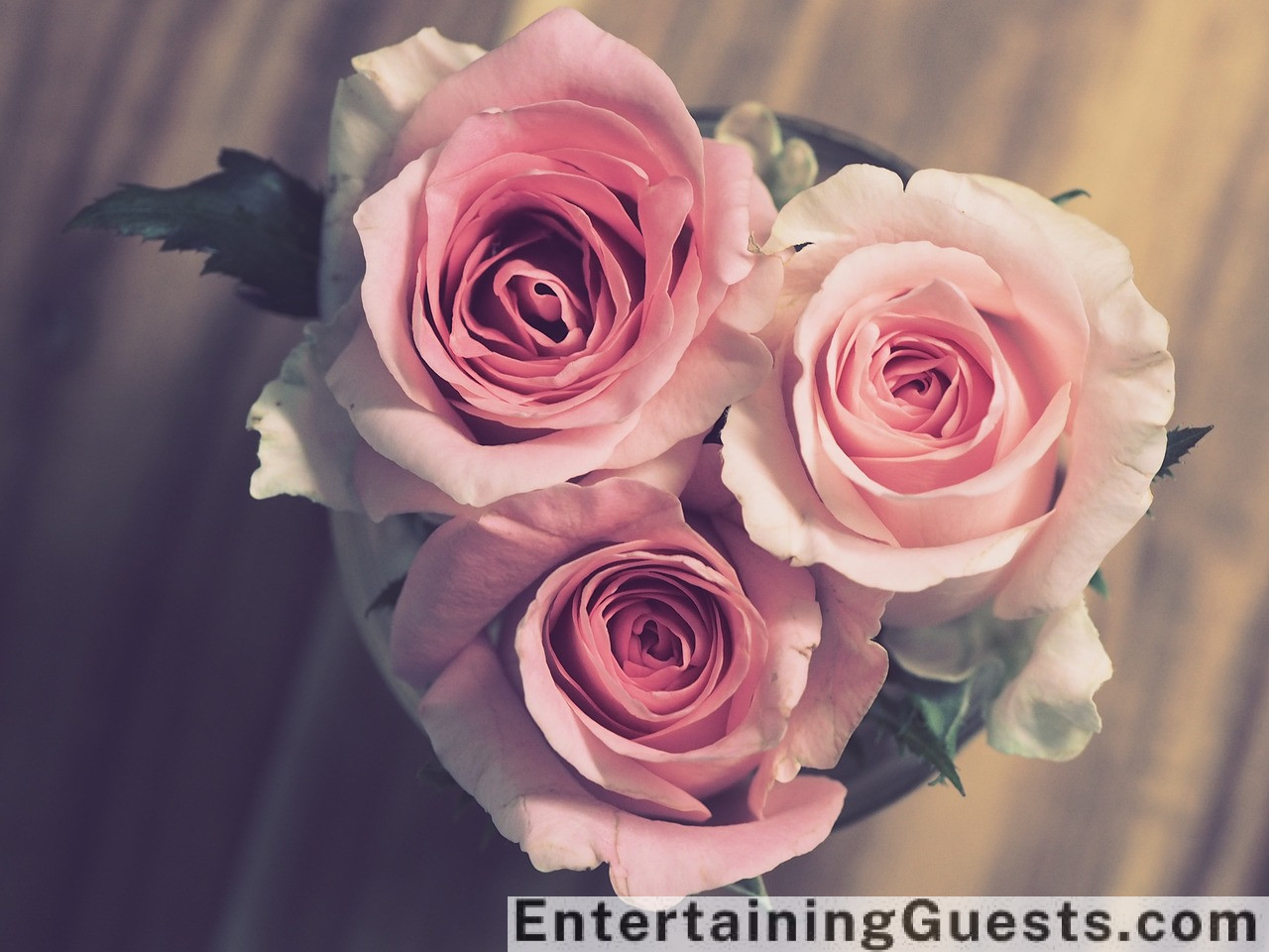 Ate an elegant wedding scene with guests enjoying a live band, a photo booth with fun props, and a magician performing tricks, all under twinkling fairy lights and lanterns