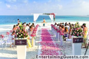 An image showcasing a joyful, diverse group of wedding guests dancing under twinkling lights, with a photo booth in the background and a laughter-filled, interactive game corner visible to the side
