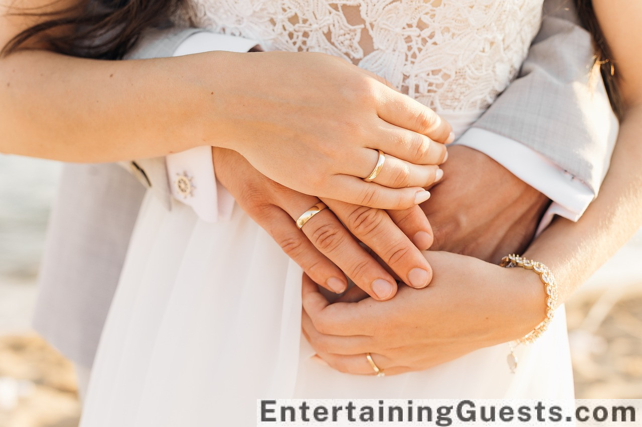 Ectic mix of vibrant colors, a whimsical wedding arch decorated with wildflowers, funfair games, a vintage carousel, and a couple laughing, wrapped in a warm sunset glow