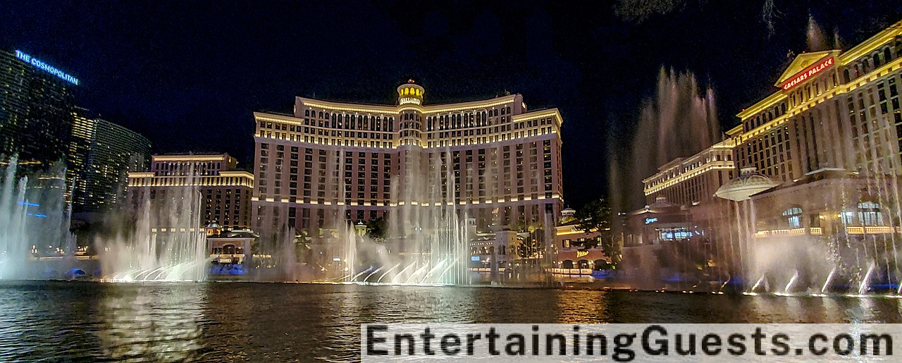 An image featuring a hotel lobby turned into a mini-concert area, with a small stage for live performances, guests enjoying the show from cozy seating areas, and staff serving gourmet snacks and drinks