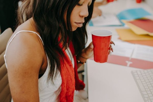 A Woman in White Dress Sitting while Planning the Party
